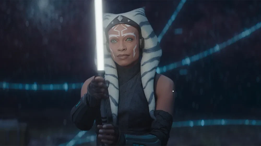 Rosario Dawson as Ahsoka Tano ignites a white lightsaber in Star Wars: Ahsoka.