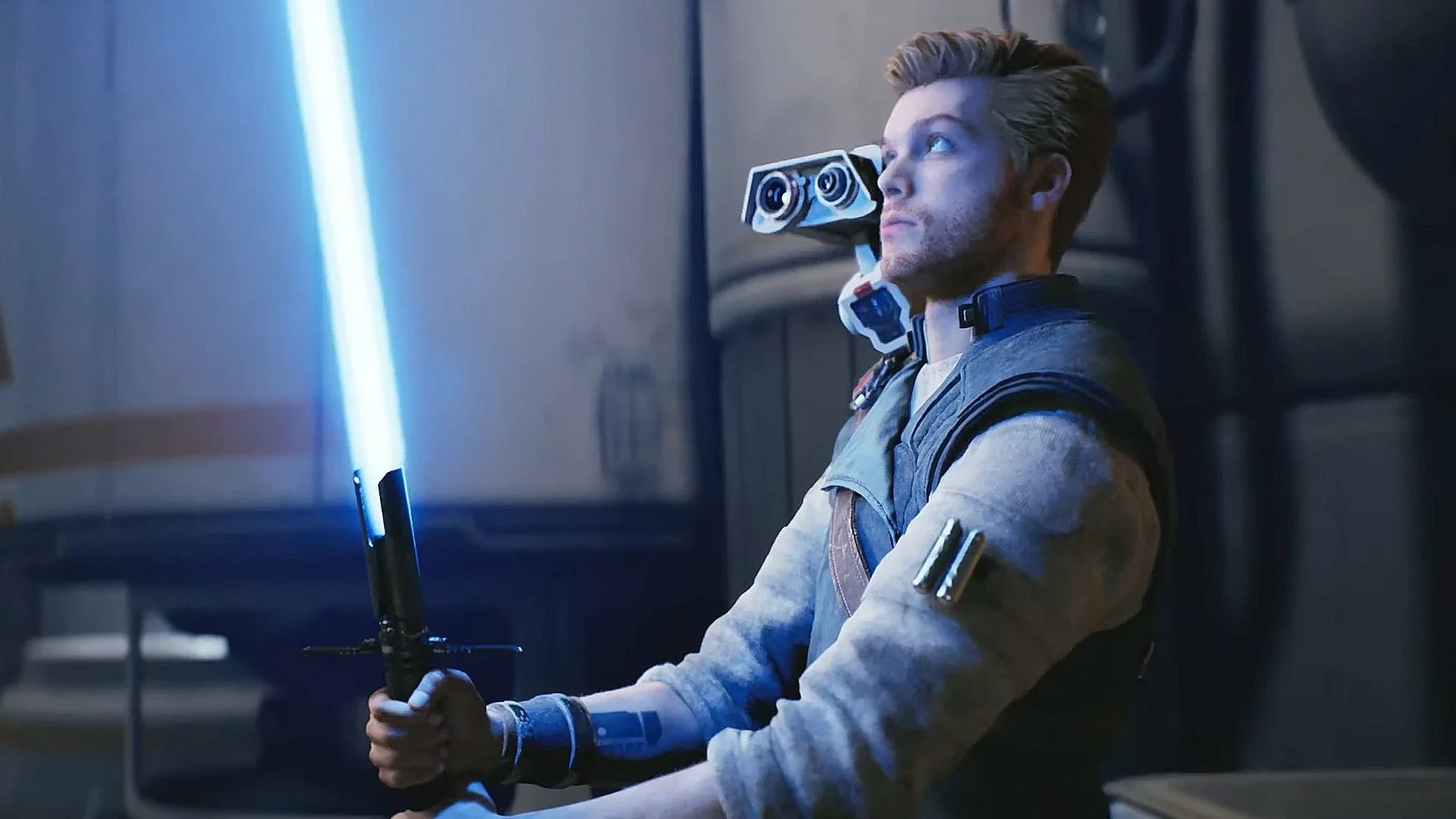 Cal Kestis ignites a blue lightsaber beside the droid BD-1 in Star Wars Jedi: Survivor.