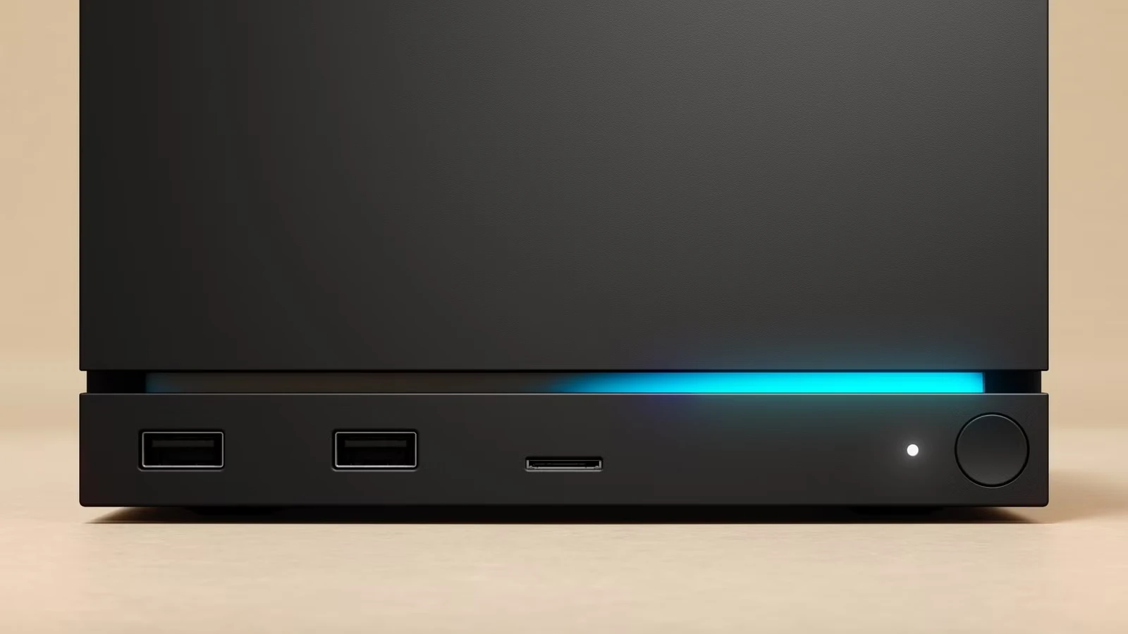 Close-up of the Steam Machine's front edge, showing two USB-A ports, a microSD card slot, a status light, a power dial, and a glowing blue light strip.