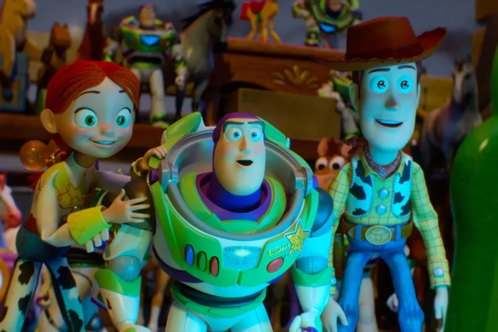 Buzz Lightyear, his helmet open, stands between Jessie and Woody amid a shelf of toys in a scene from Toy Story 5.